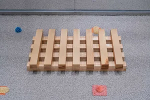 Industrial wooden furniture items arranged on a carpeted floor.