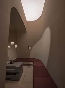 Modern interior design featuring concrete materials and minimalist furniture.