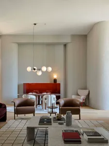 A modern interior design featuring concrete texture floors and minimalist furniture.