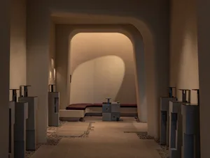A modern lobby with a concrete floor and seating area.