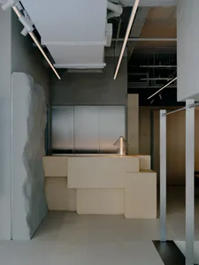 A modern office reception area with wooden and metallic elements.