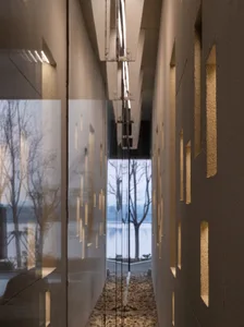 Modern entryway with glass doors and concrete walls