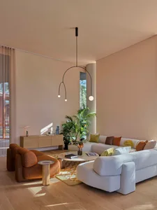 A modern living room with neutral-colored fabrics and minimalist design features.