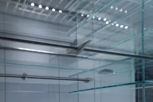 Modern industrial interior featuring glass, metal, and steel structural elements.