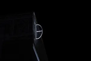 A glowing circular sign with the word 'Significant' attached to a building facade at night.