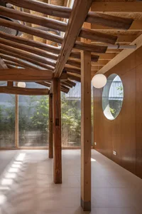 Minimalist interior space featuring wooden beams and walls.