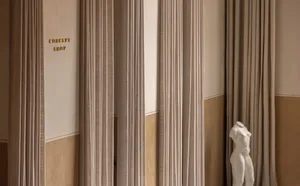 Minimalist interior design featuring textured fabric curtains.