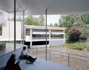 A modern architectural design featuring concrete, glass, and wood materials.
