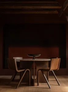 A modern, industrial-style dining area featuring wooden furniture and a minimalist design.