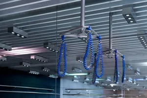 Metal cable and blue rope installation art in a modern gym