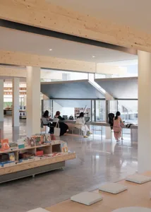 An open-plan modern workspace featuring wooden materials and minimalist design.