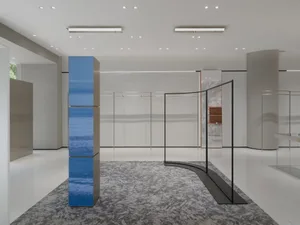 A minimalist retail store with glass, metal, and marble materials.
