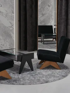 Modern living room with glass-tile flooring, minimalist decor, and large windows with dark curtains.