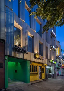 Modern building with metal cladding and large glass windows.