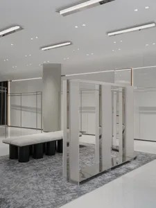 A modernist fashion retail space featuring sleek, minimalist design elements and metal-acrylic materials.