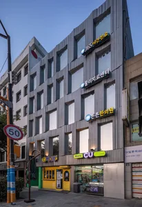 Modern storefront with glass windows and concrete facade.