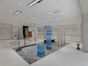 Modern retail storefront featuring glass, marble, and metal materials
