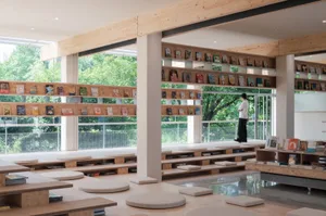 An industrial-style library with wooden shelves and a minimalist design.