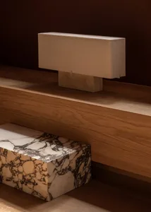 Modern interior design featuring a marble table and a concrete wall.