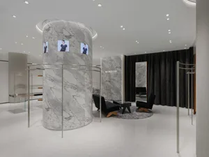 A minimalist fashion retail space featuring marble columns and high-end interior design.