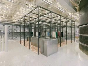 An industrial-style retail clothing shop with a steel frame and corrugated metal walls.