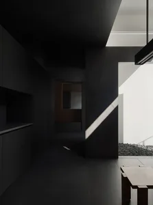 Modern minimalist interior space featuring concrete walls and floor.