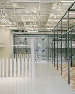 Modern industrial interior space featuring a bicycle display with concrete and metal elements.