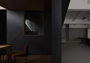 Interior design featuring modern minimalist living room with concrete walls and floor, and a fireplace.