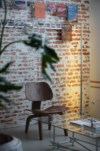 Industrial-style office space featuring brick walls and glass elements