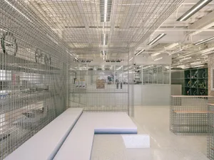 Industrial showroom featuring metallic wire mesh structures.