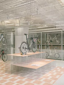 Bicycle shop with metal wire shelves displaying bicycles.