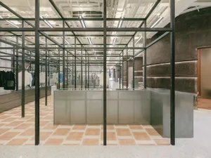 Modern minimalist retail display featuring steel, glass, and concrete elements.