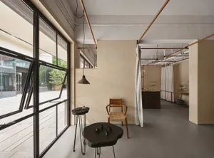 A modern, industrial-style living space with concrete walls and metal fixtures.