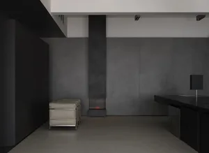 A modern industrial living room featuring concrete walls and flooring.