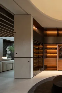 Modern interior with cement composite wine racks displaying various wine bottles