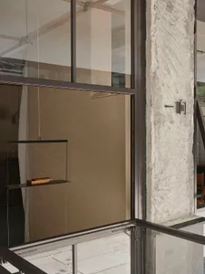 Modern minimalist interior space featuring a concrete wall and floor.