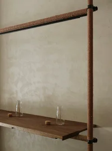 A minimalist, modern industrial interior design featuring a wooden countertop with woven rope and paper accents