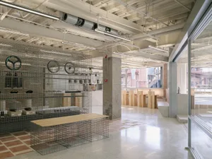 A minimalist kitchen with concrete flooring and a modern design.