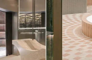 A modern lobby featuring concrete floors and curved seating.