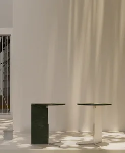 Modern marble coffee tables in minimalist room setting with natural lighting.