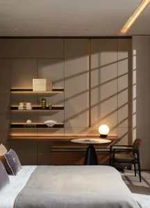 Modern minimalist bedroom featuring glass shelves, a wooden desk, and a metal lamp.