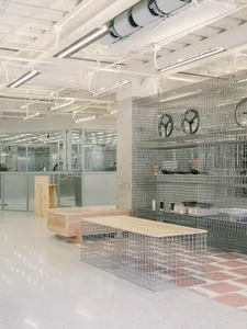 A modern retail storefront with metal shelves displaying various products.
