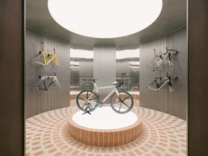 A bicycle showroom with metallic frames and a circular design layout.