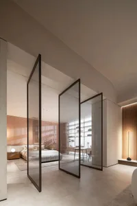Modern bedroom with glass walls and concrete floors
