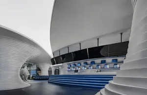 Modern retail storefront with metallic finishes and blue accents.