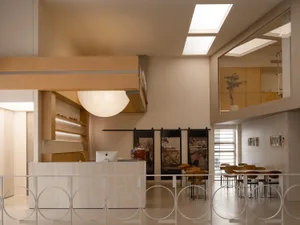A modern coffee shop interior with wooden furnishings, glass accents, and metal elements.