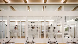 A minimalist fitness center features glass walls.