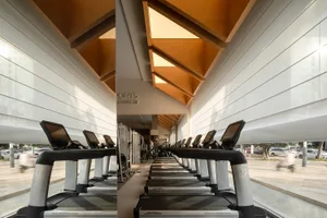 A minimalist fitness center with sleek metal treadmills and wooden accents