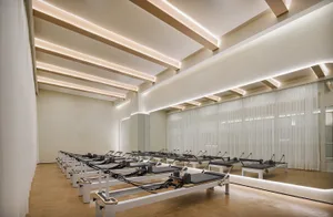 Modern, minimalist fitness center featuring wood elements