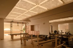 Modern minimalist fitness center with wooden equipment and clean lines.